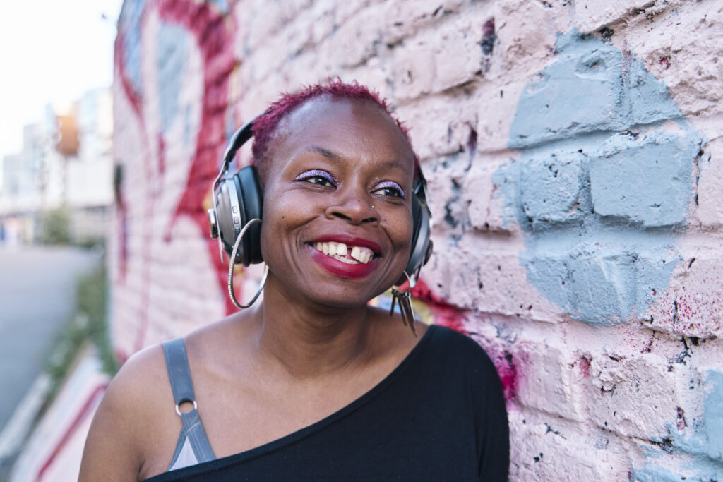 Headshot against a colourful wall in an urban London Location.