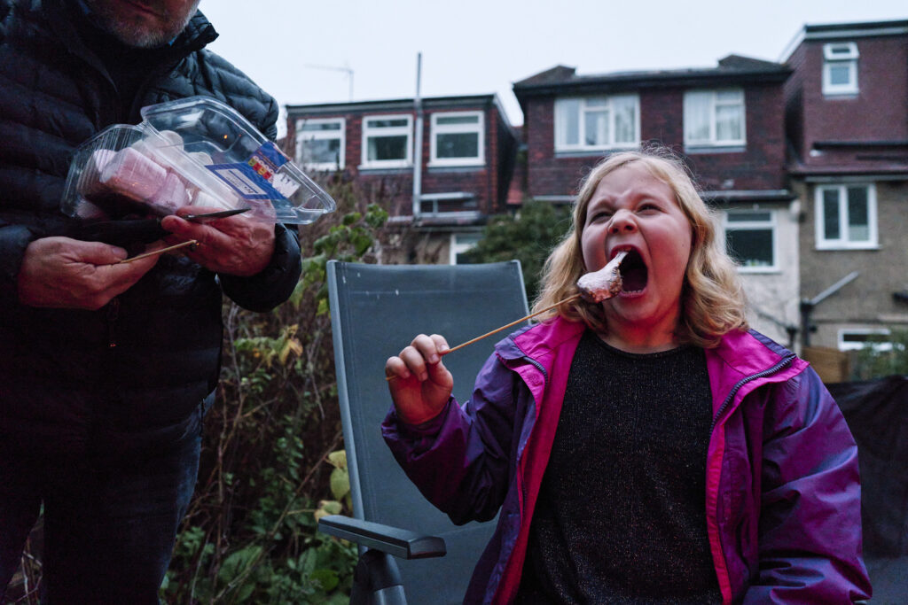 Child eating a marshmallow on a documentary family photo session showing everyday moments