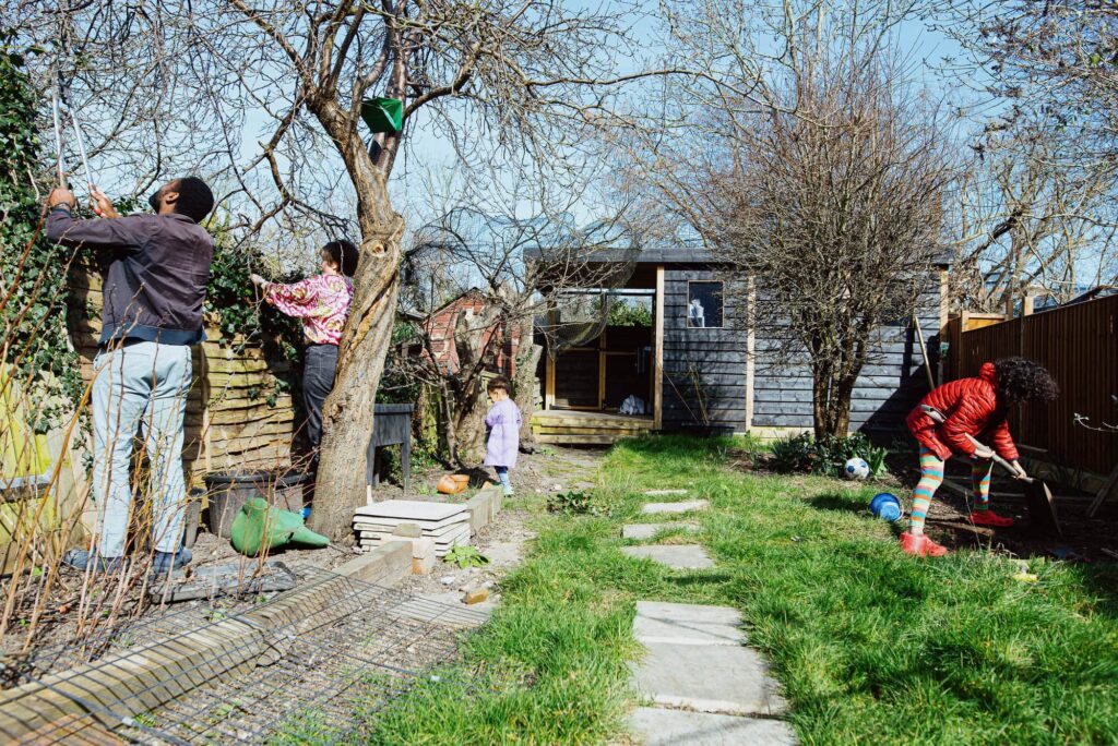 Not feeling ready for family photos doesn't have to stop you with documentary family photography as it happens along your real life like this family gardening. 