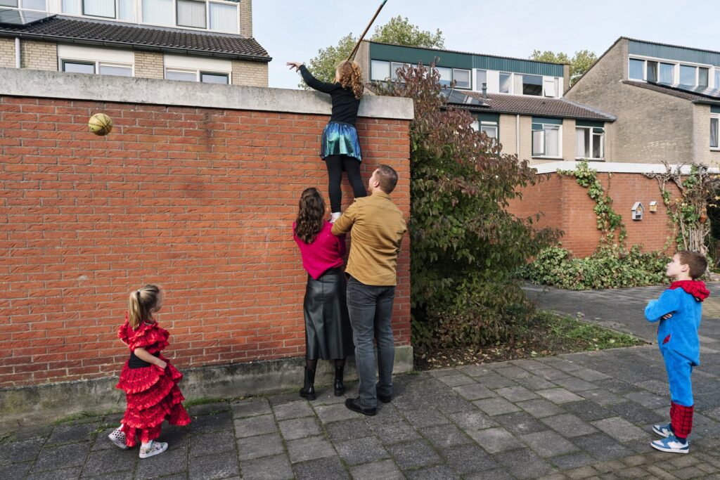 Documentary-style London photographer photographing a family playing naturally outdoors
