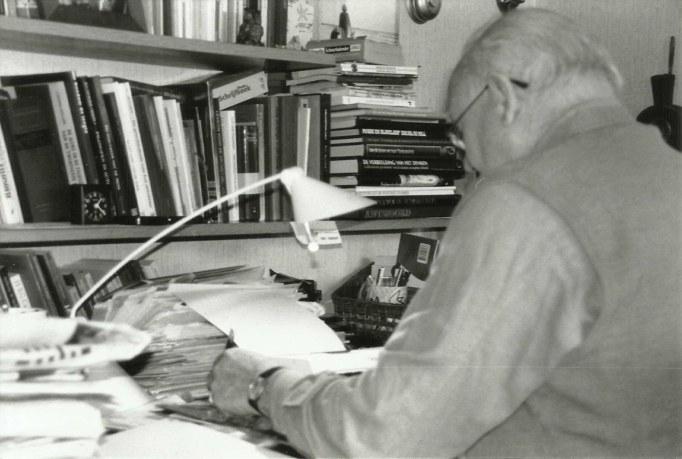 Grandfather sitting at his desk writing captured by his teen granddaughter photographer Saskia Albers.